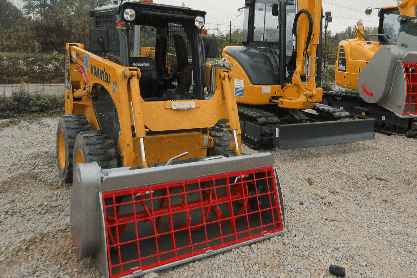 MMB250L Komatsu SK-714 Modularis Drive 250 liter concrete mixing bucket attached to Komatsu SK-714 skid-steer loader.